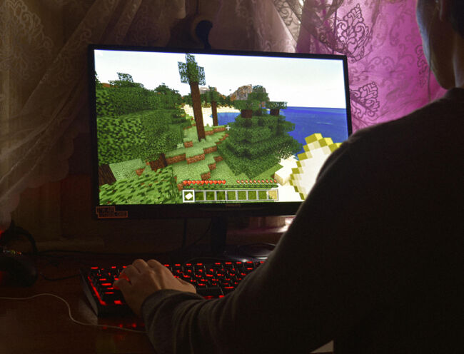 man playing a game on gaming laptop